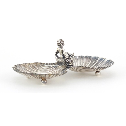 784 - Unmarked silver caviar dish, mounted with putti seated on a dolphin, 13.5cm wide, 67.0g