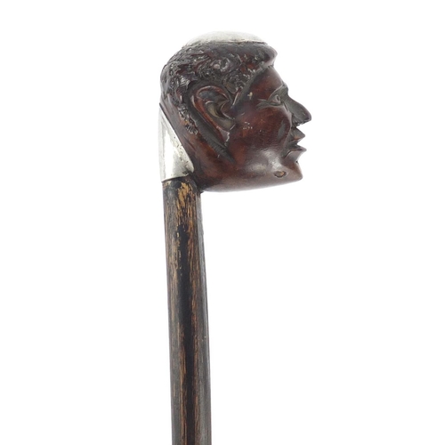 84 - Ebonised walking stick with carved head pommel and silver coloured metal mounts engraved FVL LT, 88.... 