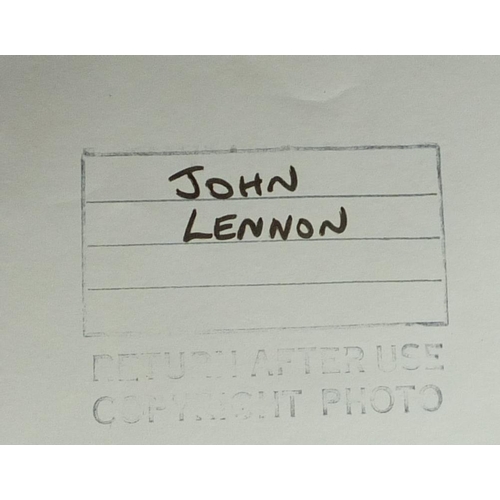 188 - 1960's black and white press photograph of John Lennon, inscribed Unicef Benefit at Lyceum 15 Dec 19... 
