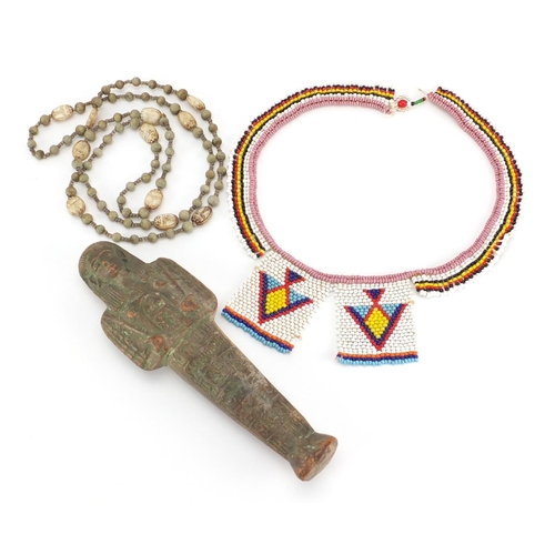 537 - Egyptian ushabti together with a scarab beetle necklace and beadwork necklace, the ushabti 19cm high