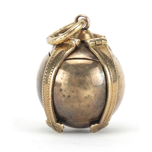 266 - 9ct gold cased Masonic folding ball pendant, approximately 2cm in diameter, 11.8g