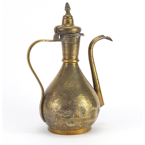 572 - Islamic brass water pot profusely engraved with calligraphy, 34cm high