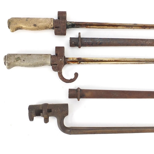 305 - Three Military interest bayonets including two with scabbards, the largest 66cm in length