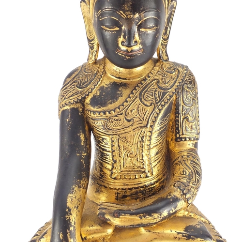 518 - Large antique Burmese carved gilt wood figure of seated Buddha, 60cm high