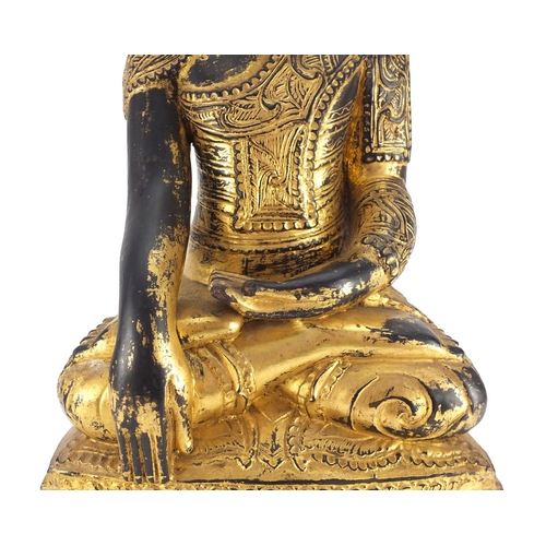 518 - Large antique Burmese carved gilt wood figure of seated Buddha, 60cm high