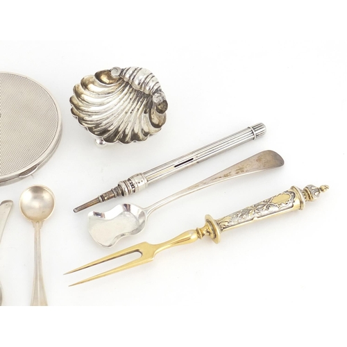 2600 - Mostly silver objects including a circular compact, shell shaped salt, mustard spoons and sugar tong... 