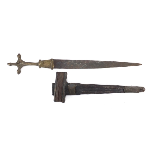 864 - Middle Eastern dagger with brass handle and leather sheath, 49cm in length