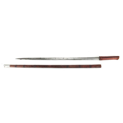 210 - Middle Eastern tooled leather sword stick, 88cm in length