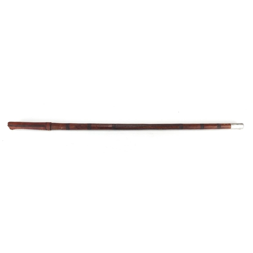 210 - Middle Eastern tooled leather sword stick, 88cm in length
