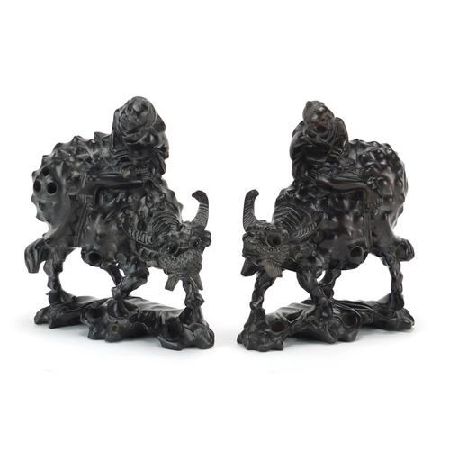 323 - Pair of Chinese carved ebony figures on water buffalo, 15cm high