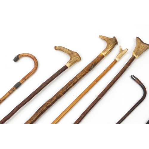 299 - Walking sticks, shepherds crooks and a Union Jack flag, three with silver mounts and four with horn ... 