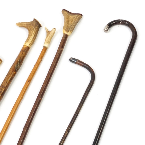 299 - Walking sticks, shepherds crooks and a Union Jack flag, three with silver mounts and four with horn ... 