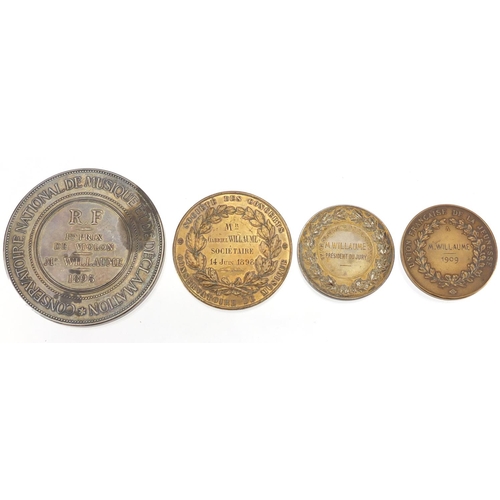 264 - Four French commemorative  medallions including a large silver medal by J C Chaplain Conservatoire N... 