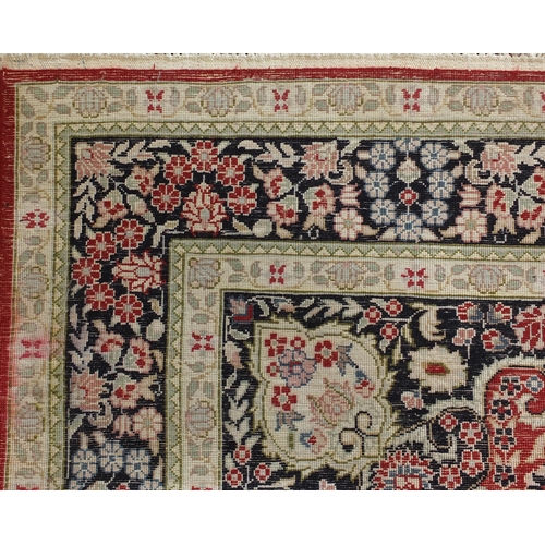 35 - Fine Rectangular silk rug having all over stylised motifs within corresponding borders, onto a midni... 