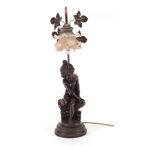 52 - Art Nouveau style bronzed nude boy lamp with pink frilled glass shade, 56cm high