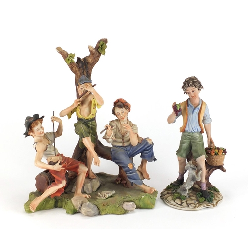 130 - Large hand painted Capodimonte figure group of three figures and one of a boy holding grapes, the la... 