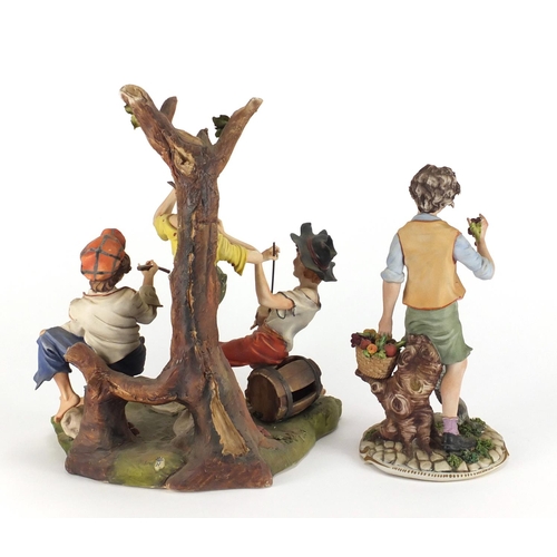 130 - Large hand painted Capodimonte figure group of three figures and one of a boy holding grapes, the la... 