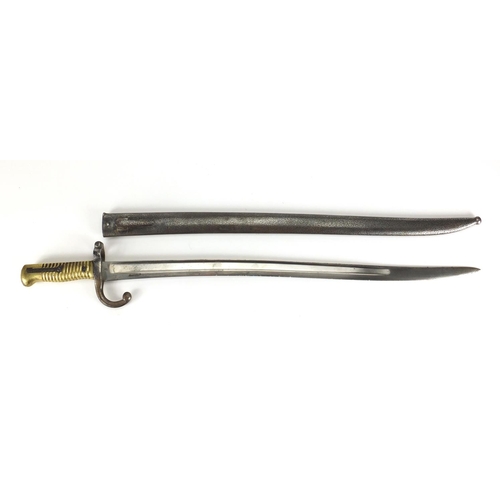 869 - Military interest bayonet and scabbard, impressed marks to the blade, 71cm in length