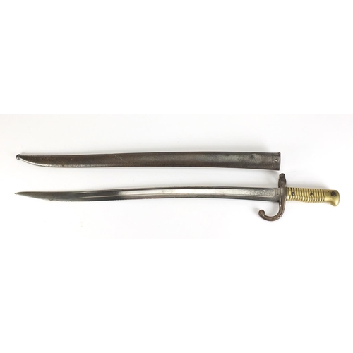 869 - Military interest bayonet and scabbard, impressed marks to the blade, 71cm in length