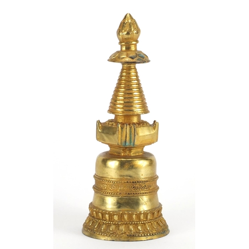 709 - Tibetan gilt bronze Stupa, 23cm high