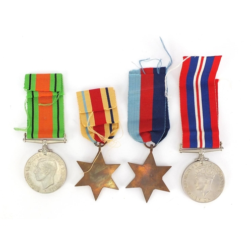 844 - Four British Military World War II medals with postage box, inscribed D R Thacker