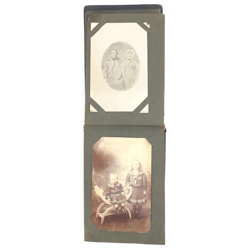 804 - Mostly early 20th century photographic postcards, arranged in an album including a solider in Milita... 