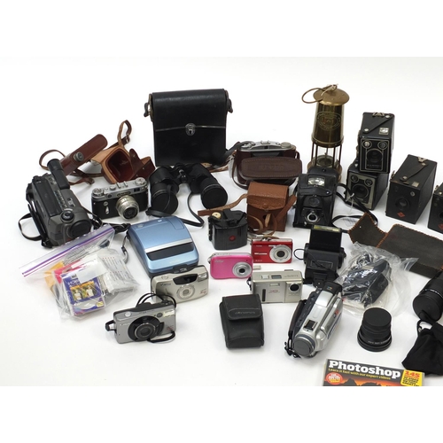 451 - Vintage cameras, binoculars and a Pavey miners lamp, including Cannon, Vivitar and Kodak