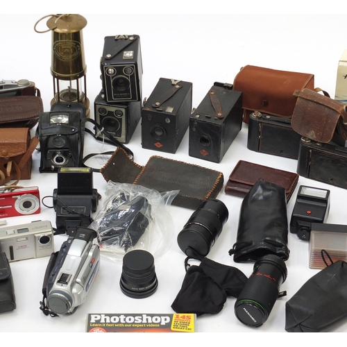 451 - Vintage cameras, binoculars and a Pavey miners lamp, including Cannon, Vivitar and Kodak
