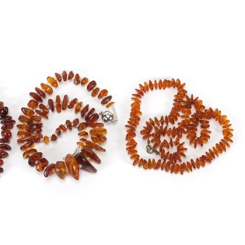 645 - Three amber coloured necklaces and a Favre-Leuba wristwatch