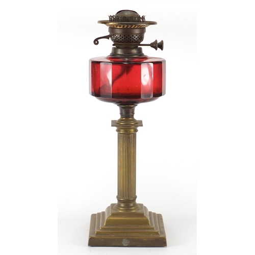 455 - Victorian brass oil lamp with red glass reservoir, 43cm high
