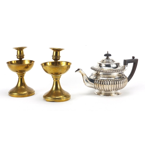 129 - Pair of antique brass candlesticks with drip trays and a silver plated teapot, the candlesticks 20cm... 