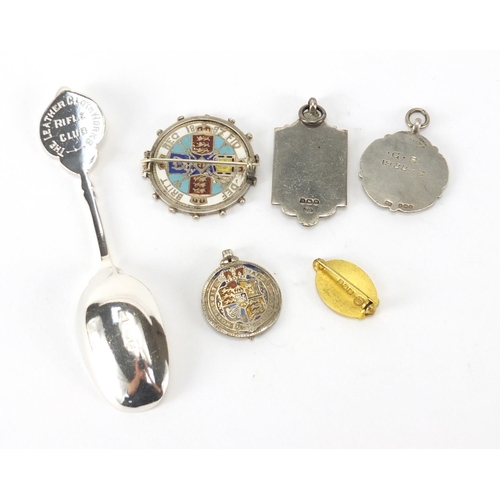 725 - Silver items including an enamelled half crown brooch, silver Rifle Club spoon and two jewels