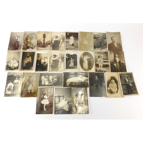 801 - Group of early 20th century mostly black and white photographic postcards