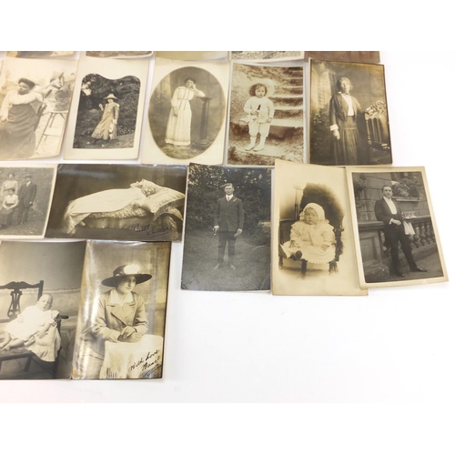 801 - Group of early 20th century mostly black and white photographic postcards