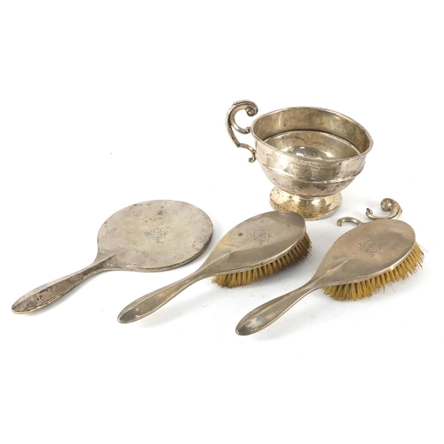 679 - Silver items comprising a trophy, two hand brushes and mirror frame, various hallmarks