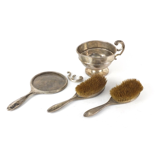 679 - Silver items comprising a trophy, two hand brushes and mirror frame, various hallmarks