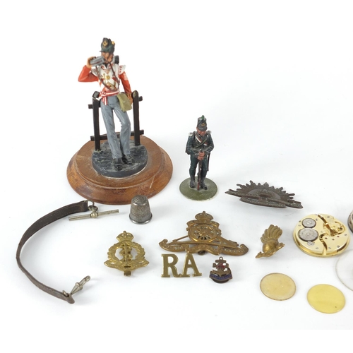 757 - Miscellaneous objects including two hand painted Military figures, Military cap badges, silver pocke... 