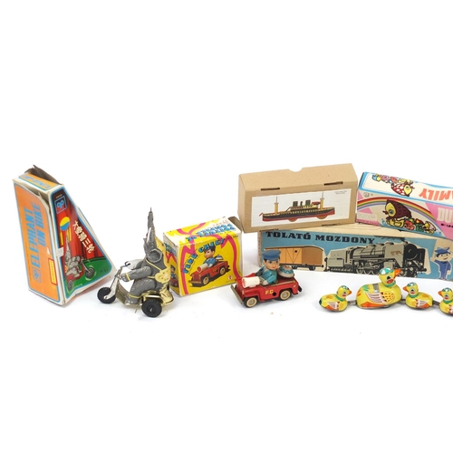 326 - Tin plate toys including rescue helicopter, drumming animal and elephant on a bike