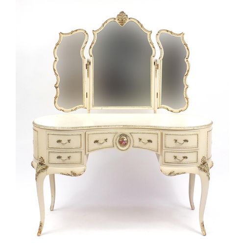 78 - French style cream and gilt kidney shape dressing table with triple mirror and five drawers, the cen... 