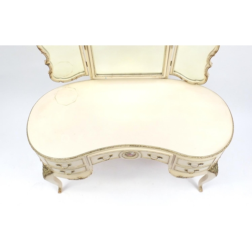 78 - French style cream and gilt kidney shape dressing table with triple mirror and five drawers, the cen... 