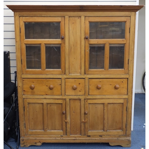 14 - Victorian pine side cabinet with a pair of glazed doors above three drawers and a pair of cupboard d... 