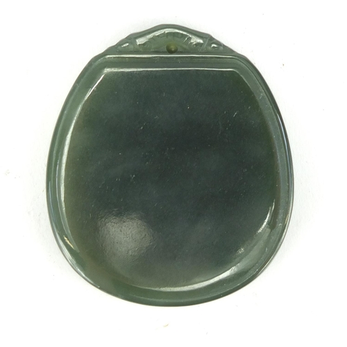 702 - Chinese green jade pendant. 4.7cm in length