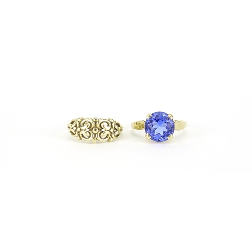 2807 - 9ct gold blue stone solitaire ring, size N and a 9ct gold floral ring, size M, 5.0g