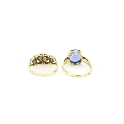 2807 - 9ct gold blue stone solitaire ring, size N and a 9ct gold floral ring, size M, 5.0g