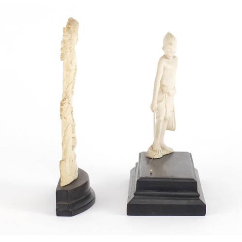 544 - Two antique ivory carvings including and Indian example of a fisherman, both raised on ebony bases, ... 
