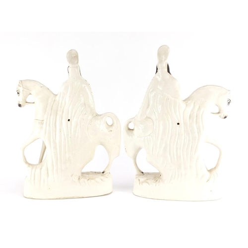 618 - Pair of Victorian Staffordshire flat back figures of figures on horsebacks, the largest 38cm high