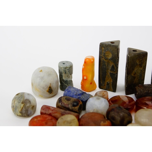 534 - Collection of beads and stones including Islamic carved agate examples, the largest approximately 3.... 