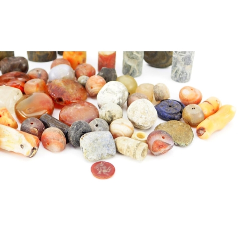 534 - Collection of beads and stones including Islamic carved agate examples, the largest approximately 3.... 