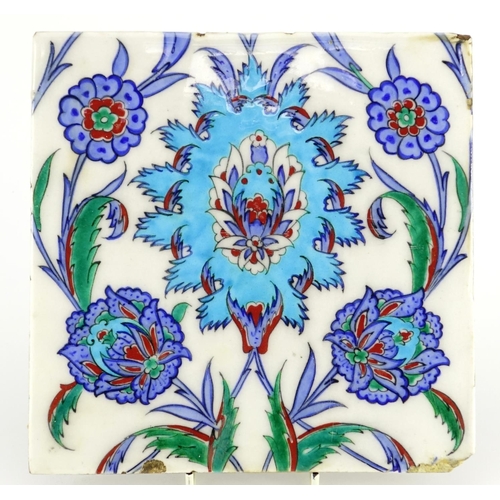 557 - Turkish Kutahya tile hand painted with flowers and foliage, 21cm x 21cm