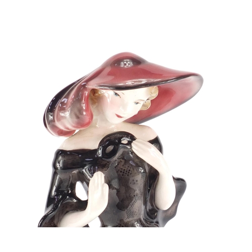 712 - Austrian Art Deco figurine of a girl wearing a pink hat and dress by Goldscheider, factory marks and... 
